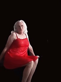 A girl in tart clothes plays with a dildo and simulates sex